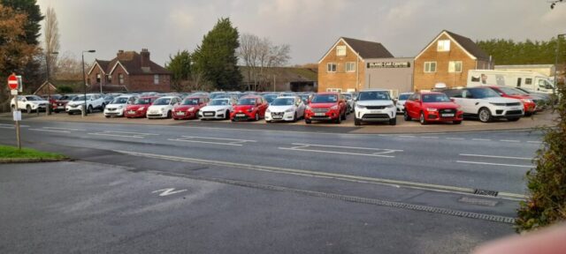Island Car Centre – red and white cars in line at Christmas time